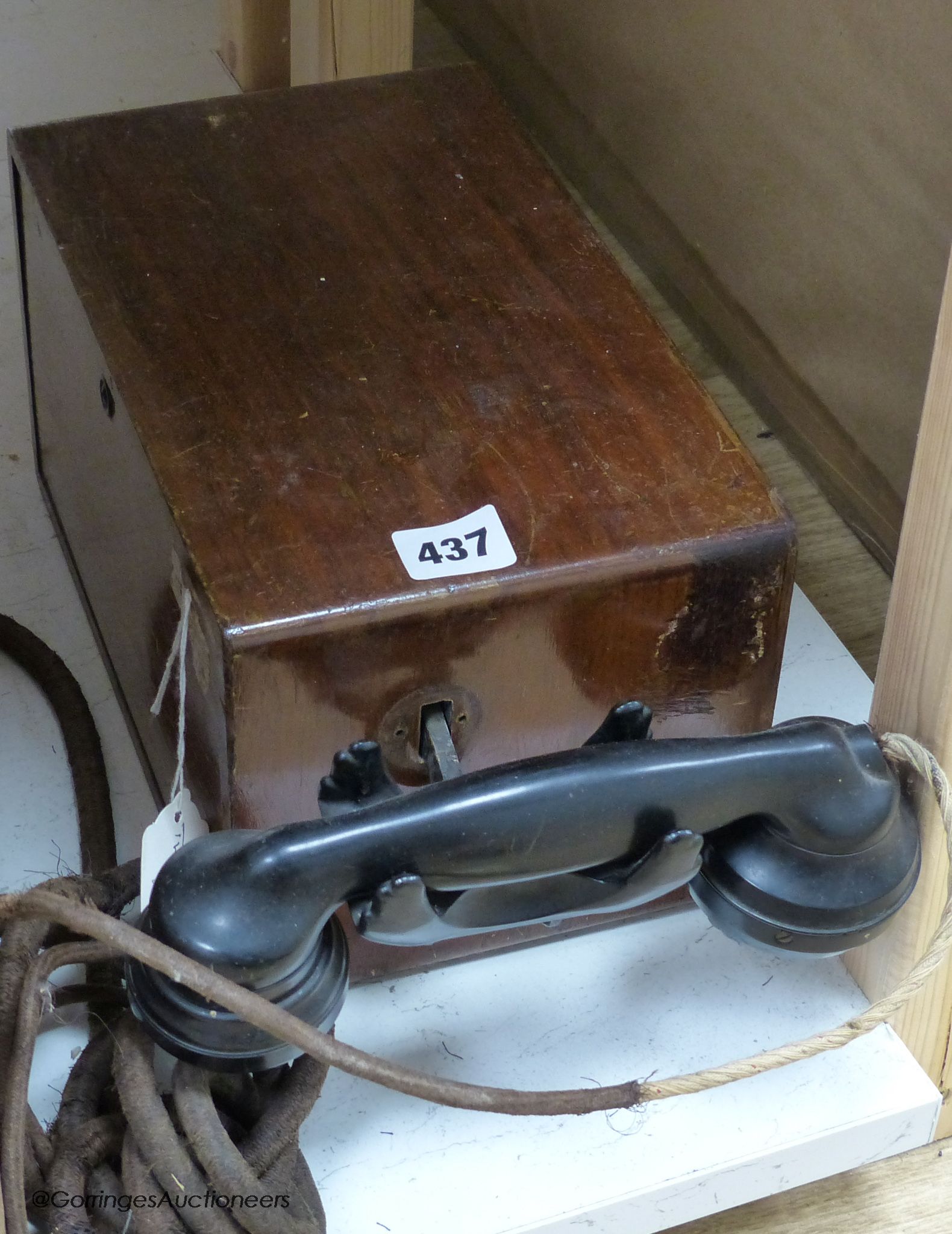 A vintage walnut-cased telephone switchboard with black Bakelite handset